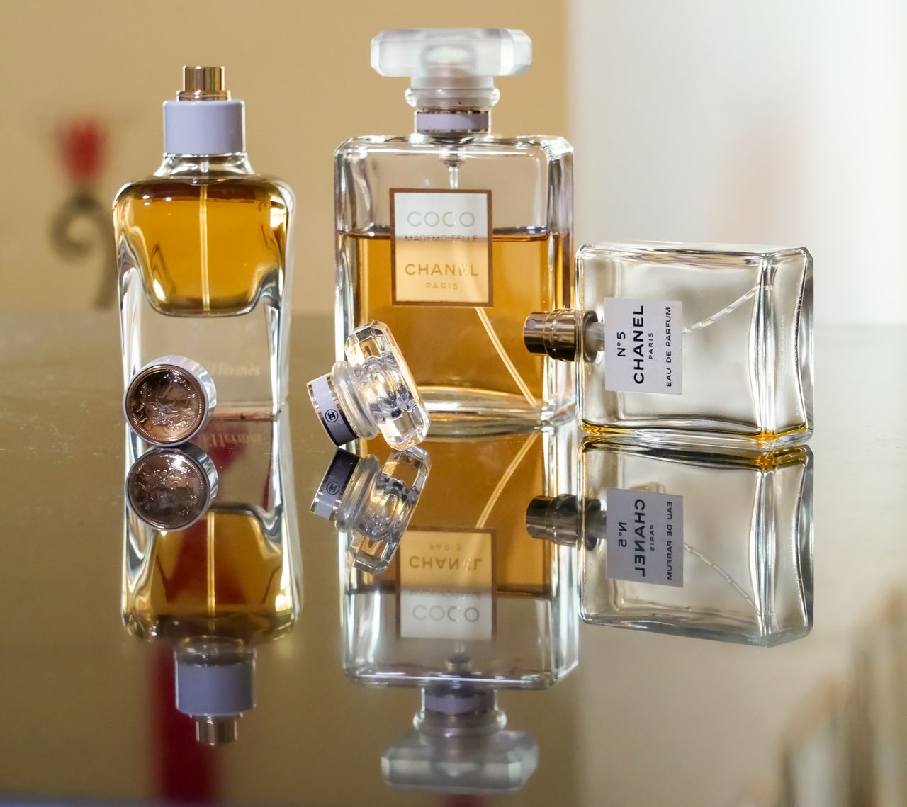 team-02 Luxury perfume bottles elegantly arranged, creating stunning reflections showcasing brand elegance.