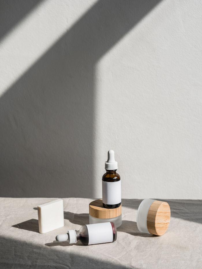 services-02 Stylish layout of skincare products with dropper bottles and jars against a soft backdrop.